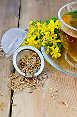 Image showing Herbal tea from tutsan dry in strainer with cup