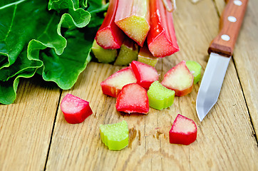 Image showing Rhubarb cut with a knife on a board