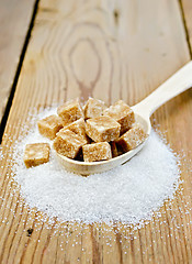 Image showing Sugar brown and granulated sugar in a spoon on the board