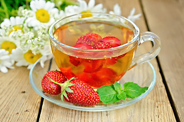 Image showing Tea with strawberries on a board