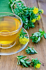 Image showing Herbal tea with Rhodiola rosea in the cup on the board