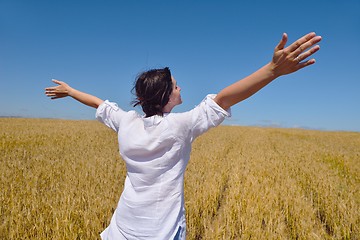 Image showing young woman with spreading arms to sky