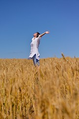 Image showing young woman with spreading arms to sky