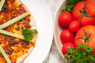 Image showing Turkish beef pizza with cucumber on top