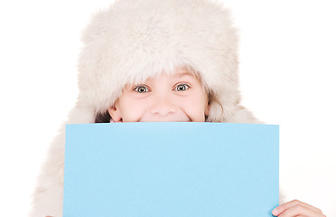 Image showing girl in winter hat with blank board