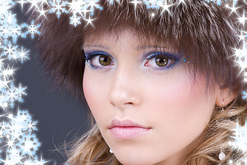 Image showing lovely woman in furry hat over grey