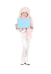 Image showing girl in winter hat with blank board