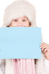 Image showing girl in winter hat with blank board