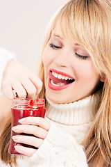 Image showing happy teenage girl with raspberry jam