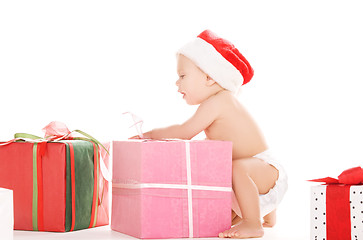 Image showing santa helper baby with christmas gifts