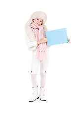 Image showing girl in winter hat with blank board