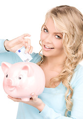 Image showing lovely woman with piggy bank and money