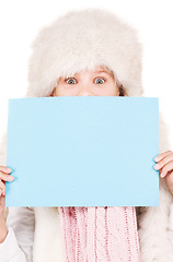 Image showing girl in winter hat with blank board