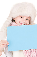 Image showing girl in winter hat with blank board