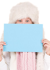 Image showing girl in winter hat with blank board