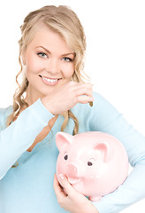 Image showing lovely woman with piggy bank