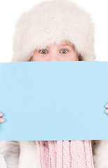 Image showing girl in winter hat with blank board