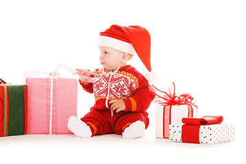 Image showing santa helper baby with christmas gifts