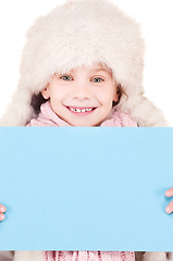 Image showing girl in winter hat with blank board