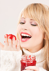 Image showing happy teenage girl with raspberry jam