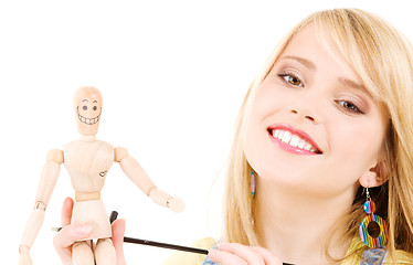 Image showing happy teenage girl with wooden model dummy