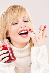 Image showing happy teenage girl with raspberry jam