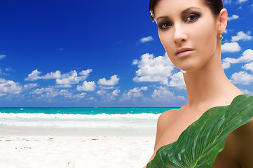 Image showing woman with green leaf on tropical beach