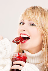 Image showing happy teenage girl with raspberry jam