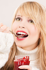 Image showing happy teenage girl with raspberry jam