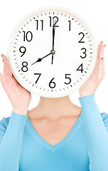 Image showing woman with big clock covering face