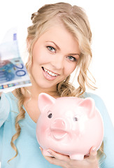 Image showing lovely woman with piggy bank and money