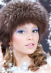 Image showing lovely woman in furry hat over grey