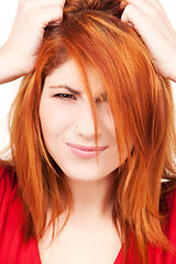 Image showing unhappy redhead woman