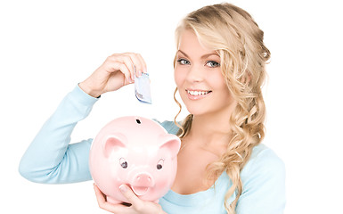 Image showing lovely woman with piggy bank and money