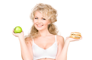 Image showing woman choosing between burger and apple