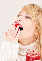 Image showing happy teenage girl with raspberry jam