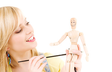 Image showing happy teenage girl with wooden model dummy