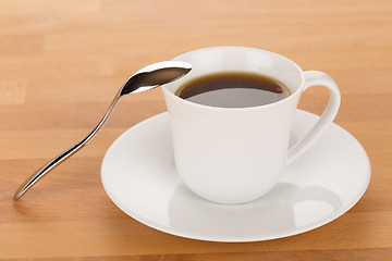 Image showing Cup of coffee and silver spoon