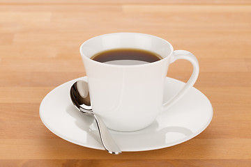 Image showing Cup of coffee and silver spoon