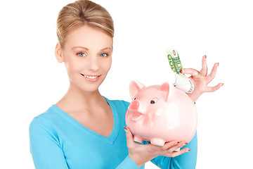 Image showing lovely woman with piggy bank and money