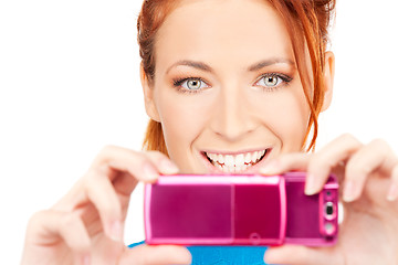 Image showing happy woman using phone camera