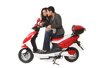 Image showing couple girls talking on  scooter