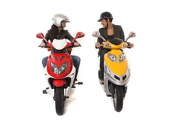 Image showing couple girls talking on  scooter