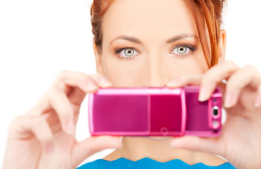 Image showing redhead woman using phone camera