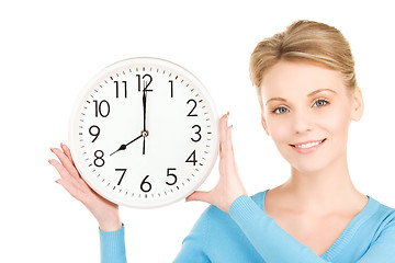 Image showing woman holding big clock