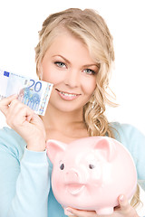 Image showing lovely woman with piggy bank and money