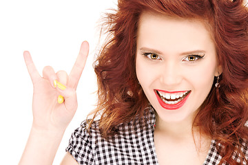 Image showing happy teenage girl showing devil horns gesture