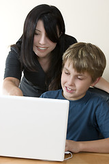 Image showing Adult woman and child at computer