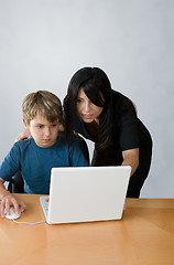 Image showing Adult assisting child on computer