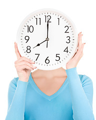 Image showing woman with big clock covering face